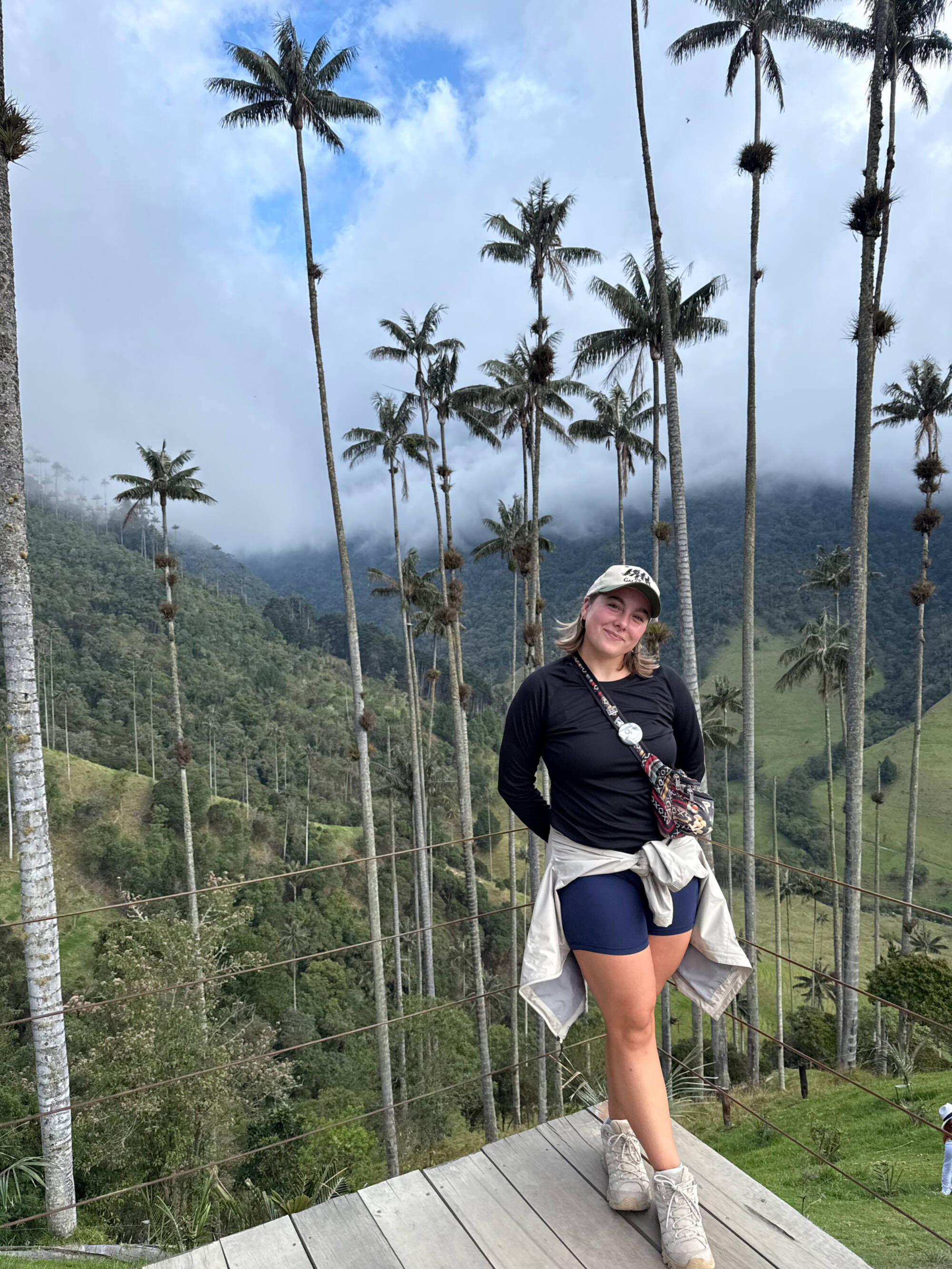 Jacey in front of a hills and trees in Colombia